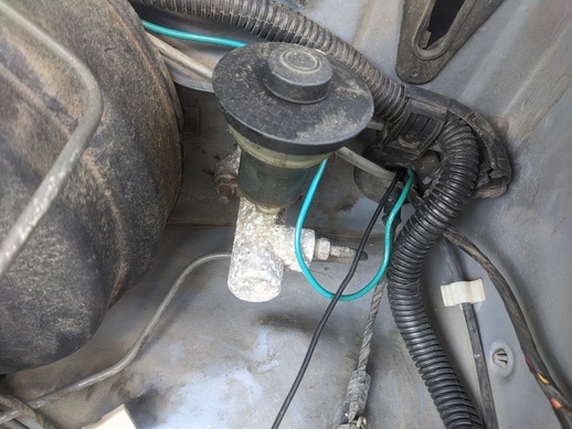 I used the hole right of the clutch master cylinder